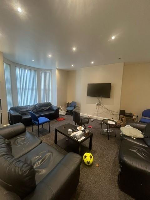A spacious and modern living room featuring com...