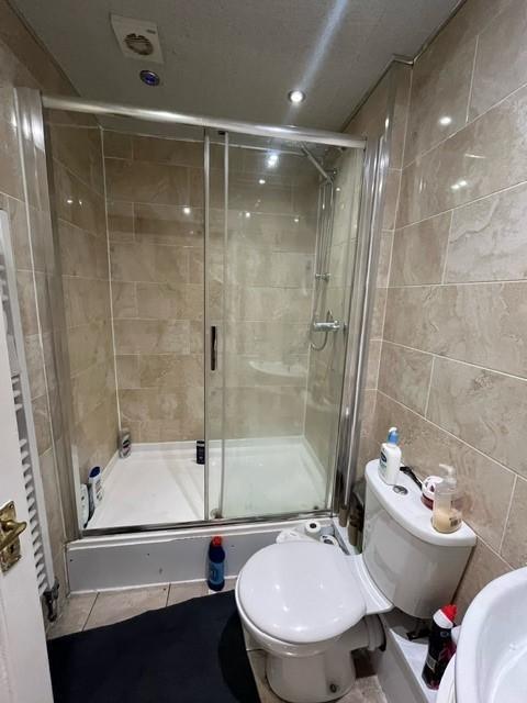 A clean and modern bathroom featuring a large s...