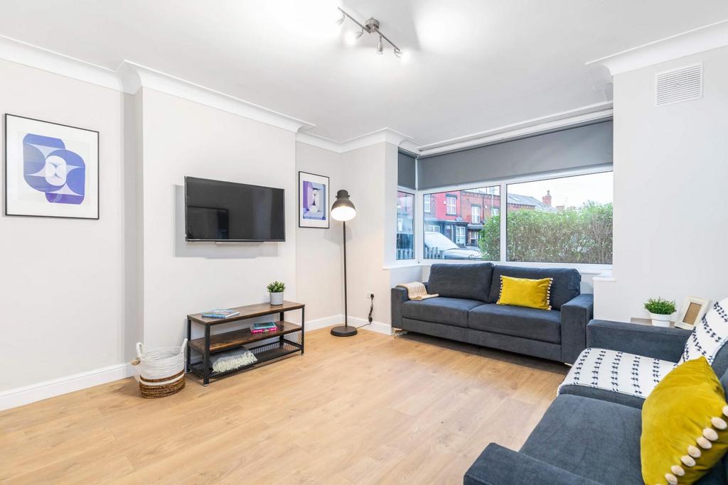 A modern, well-lit living room featuring comfor...