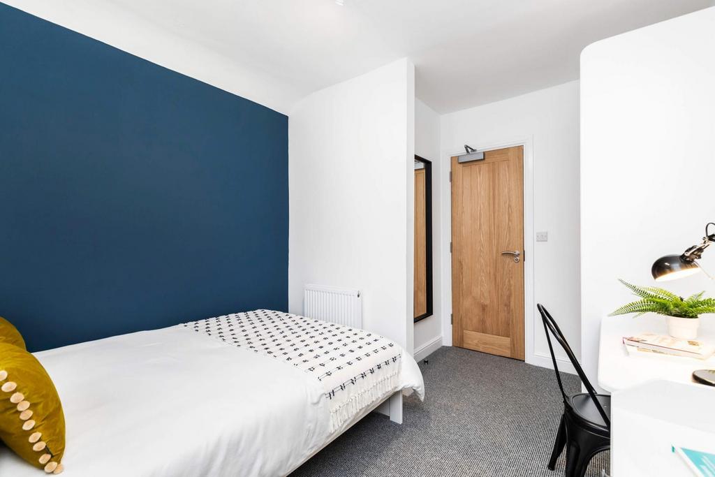 A clean and well-lit small restroom with a simp...