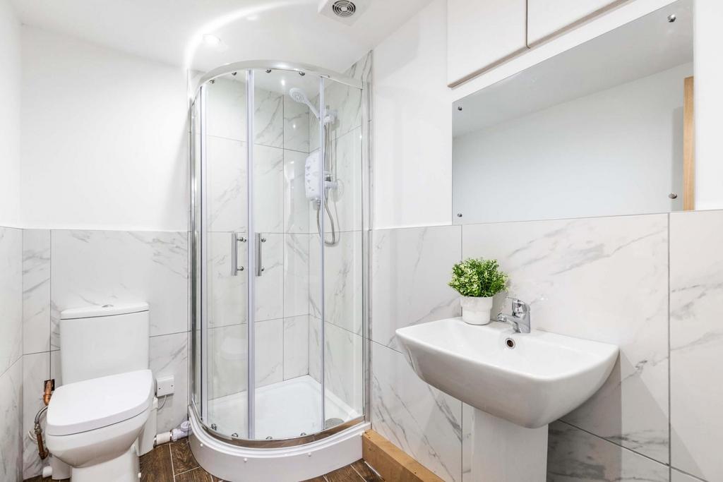 A modern, clean bathroom featuring a spacious s...