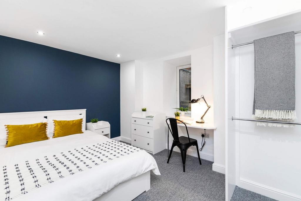 A well-presented bedroom featuring a comfortabl...