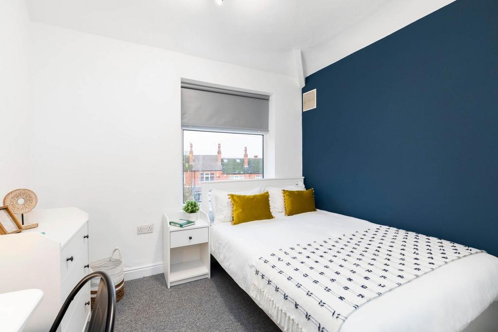 A bright and welcoming master bedroom featuring...