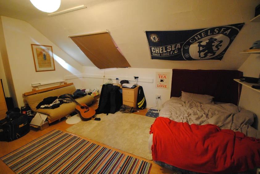 A cozy bedroom featuring a double bed, a study ...