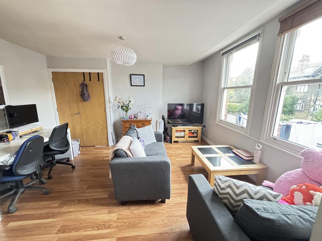 A bright and welcoming living room with large w...