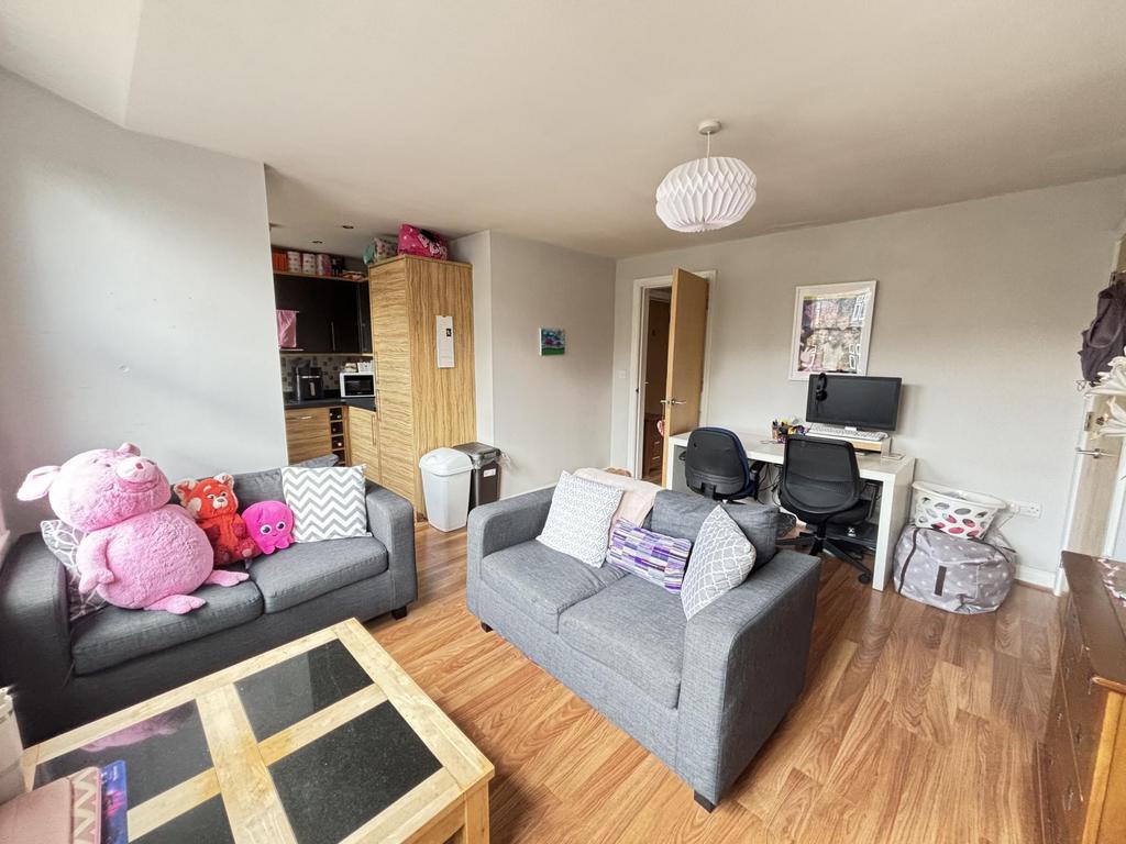 A bright and welcoming living room with comfort...