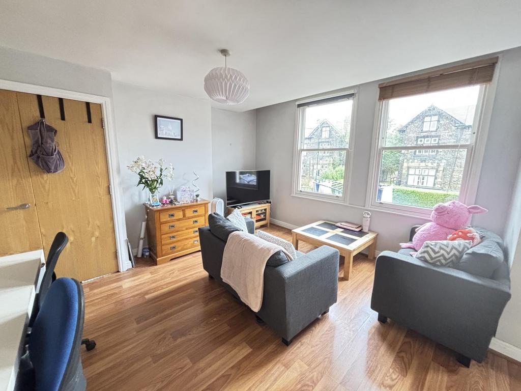 Bright and welcoming living room featuring ampl...