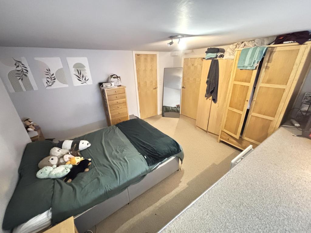 A cozy student bedroom featuring a double bed, ...