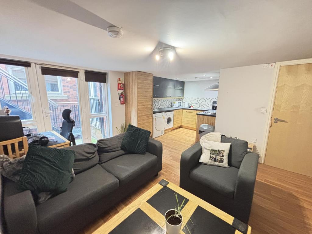 A spacious and welcoming living room featuring ...