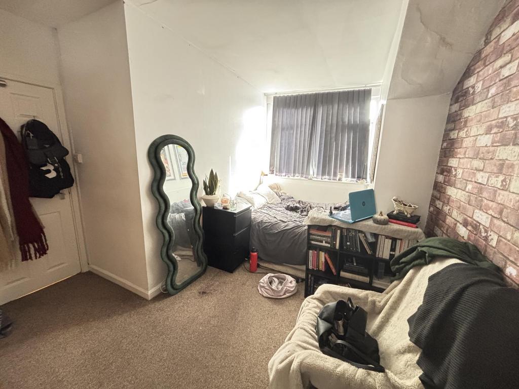 Cosy bedroom with soft carpeting, a comfortable...