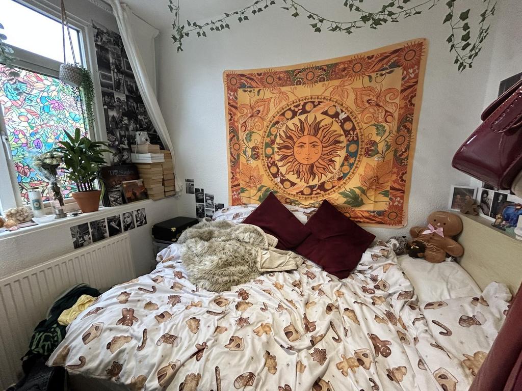 A cozy master bedroom featuring a large bed wit...