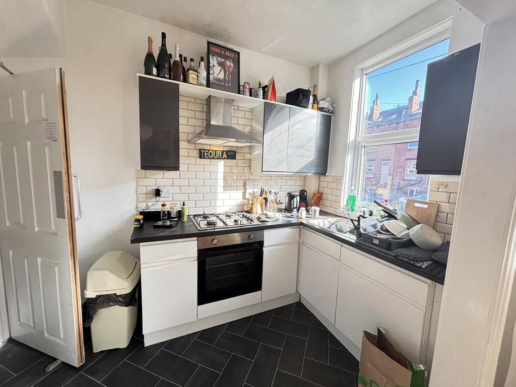 A bright, well-lit kitchen with modern cabinetr...
