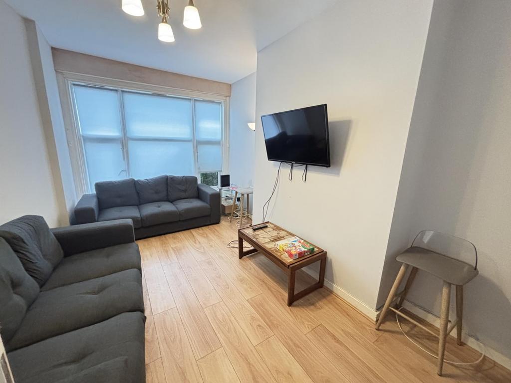 A bright and inviting living room featuring a c...