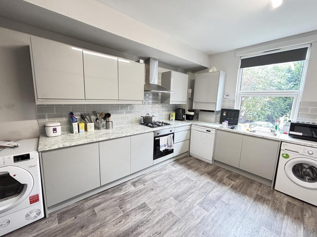Bright and modern kitchen with ample natural li...