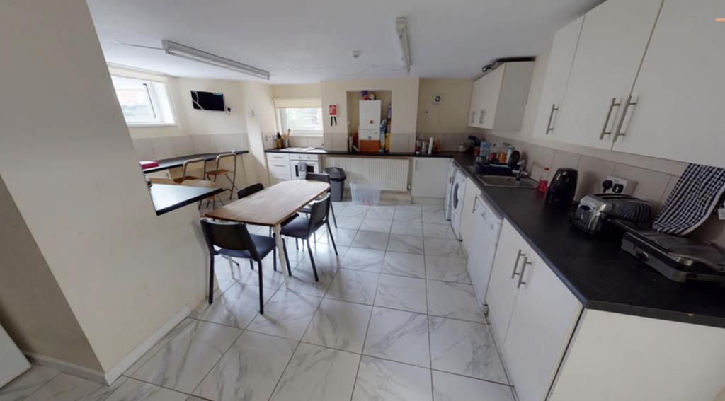 Modern kitchen featuring ample cabinetry and wo...