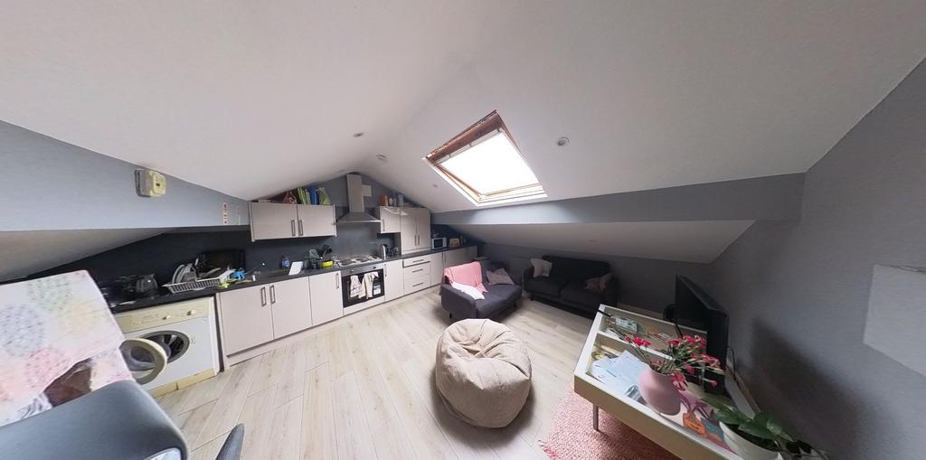 A spacious and well-lit contemporary living roo...