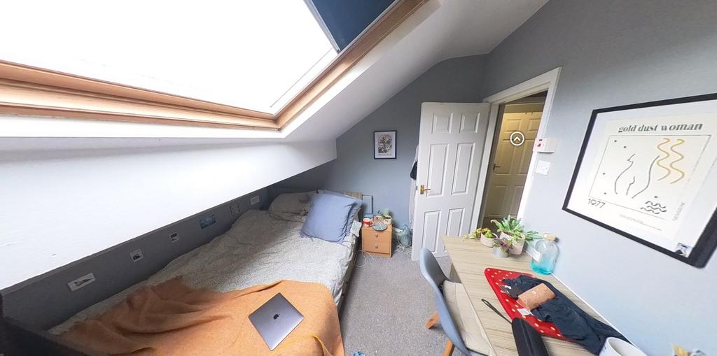A bright and well-maintained bedroom featuring ...