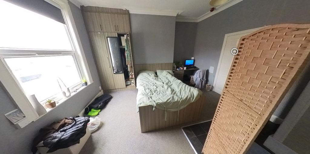 A cozy bedroom featuring a double bed and a win...
