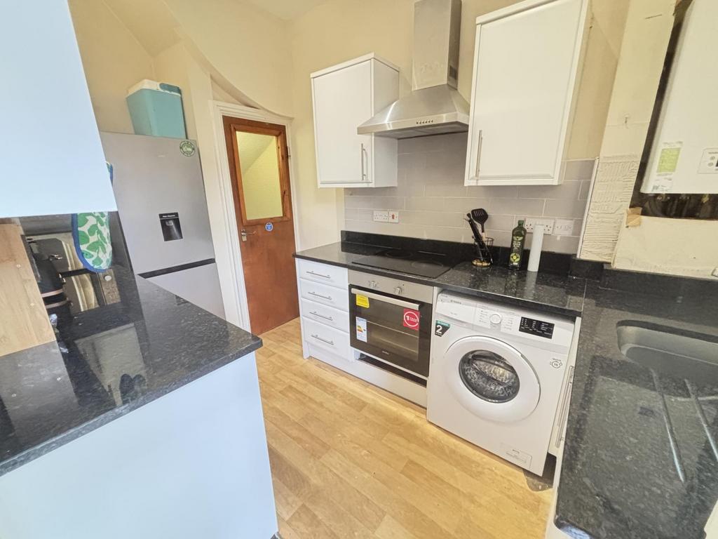 A modern, well-maintained kitchen featuring whi...