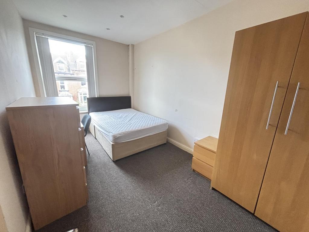 A well-maintained bedroom featuring a comfortab...