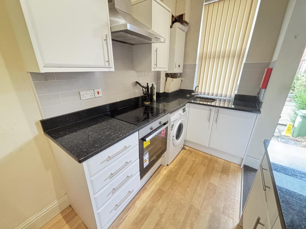 Bright and clean kitchen area with modern appli...