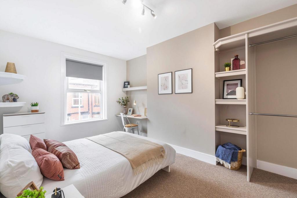 A bright, well-maintained bedroom featuring a c...