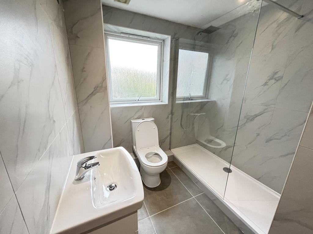A clean and modern bathroom featuring a large s...