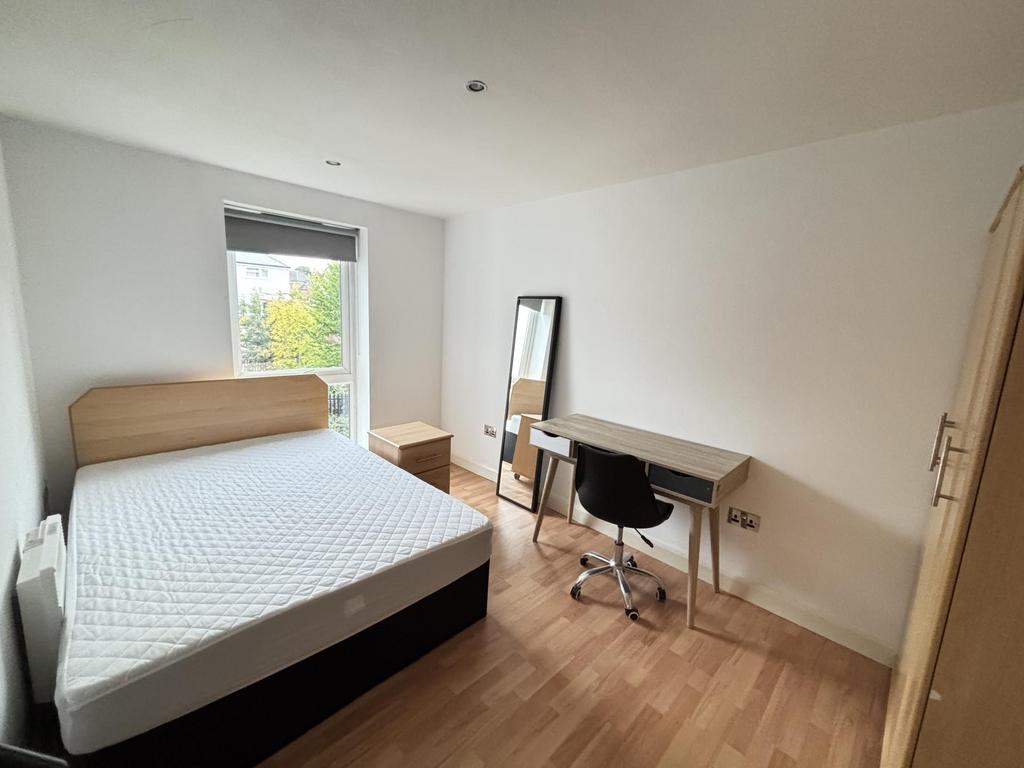 A bright and neat bedroom featuring a comfortab...