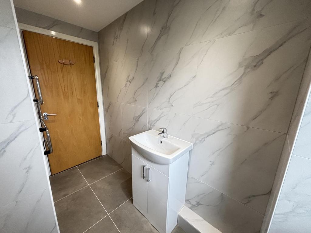 A clean and modern bathroom with a large bathtu...