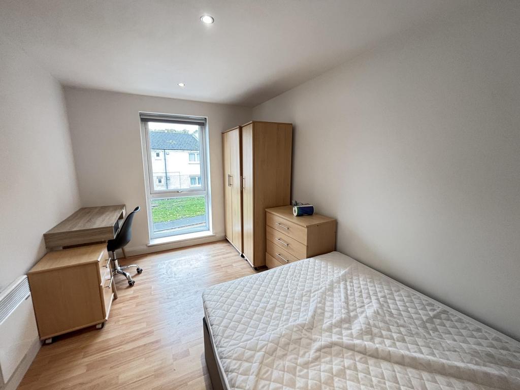 A bright and neatly presented bedroom featuring...