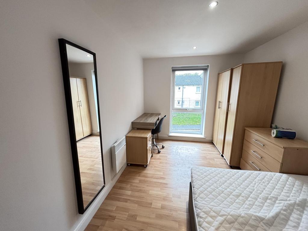 Bright and airy bedroom featuring a comfortable...