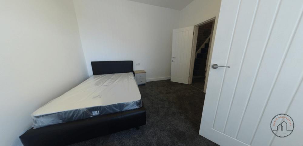 A cozy bedroom featuring a comfortable well-mad...