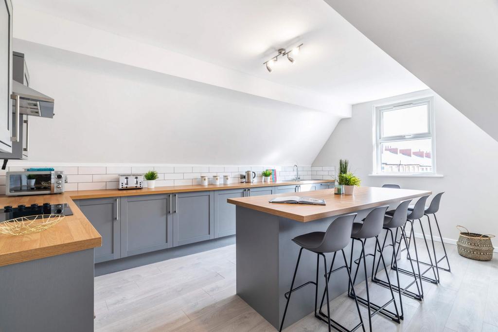 A modern, well-lit kitchen featuring sleek ligh...
