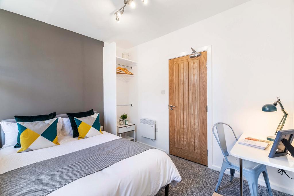 A well-maintained bedroom featuring a double be...