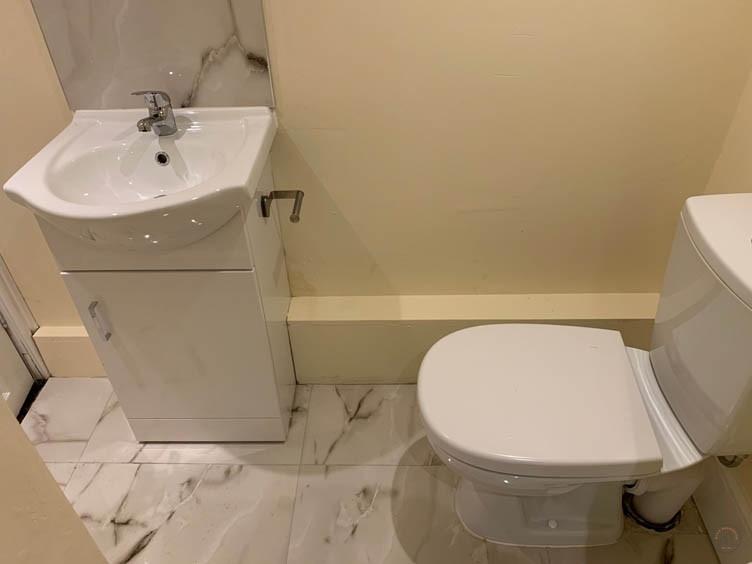 A clean and modern bathroom with a white toilet...