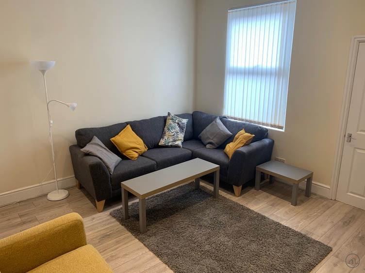 A spacious and well-maintained living room feat...