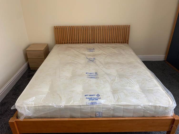A spacious master bedroom featuring a comfortab...