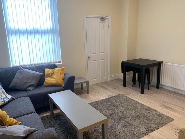 A bright and welcoming living room featuring a ...
