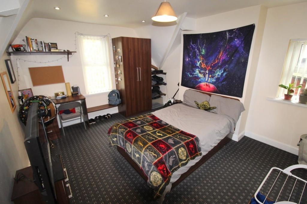 A spacious and well-kept master bedroom featuri...