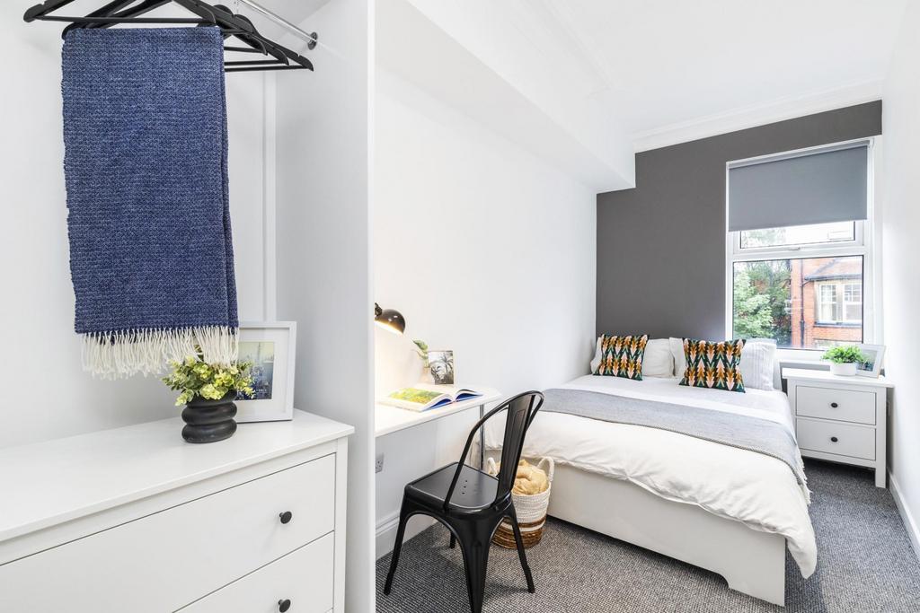 Bright and welcoming master bedroom featuring a...