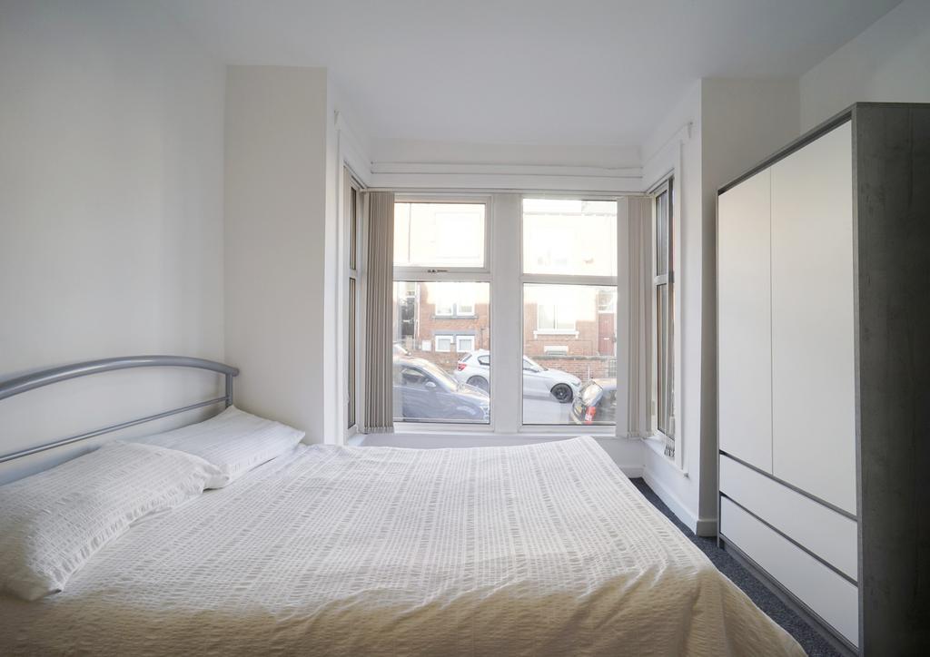Bright and inviting bedroom with a large window...