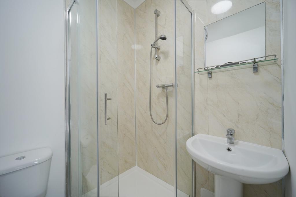 A modern bathroom suite featuring a clean showe...
