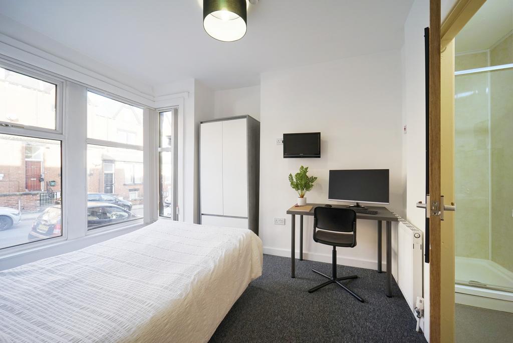 A bright and modern bedroom with large windows ...