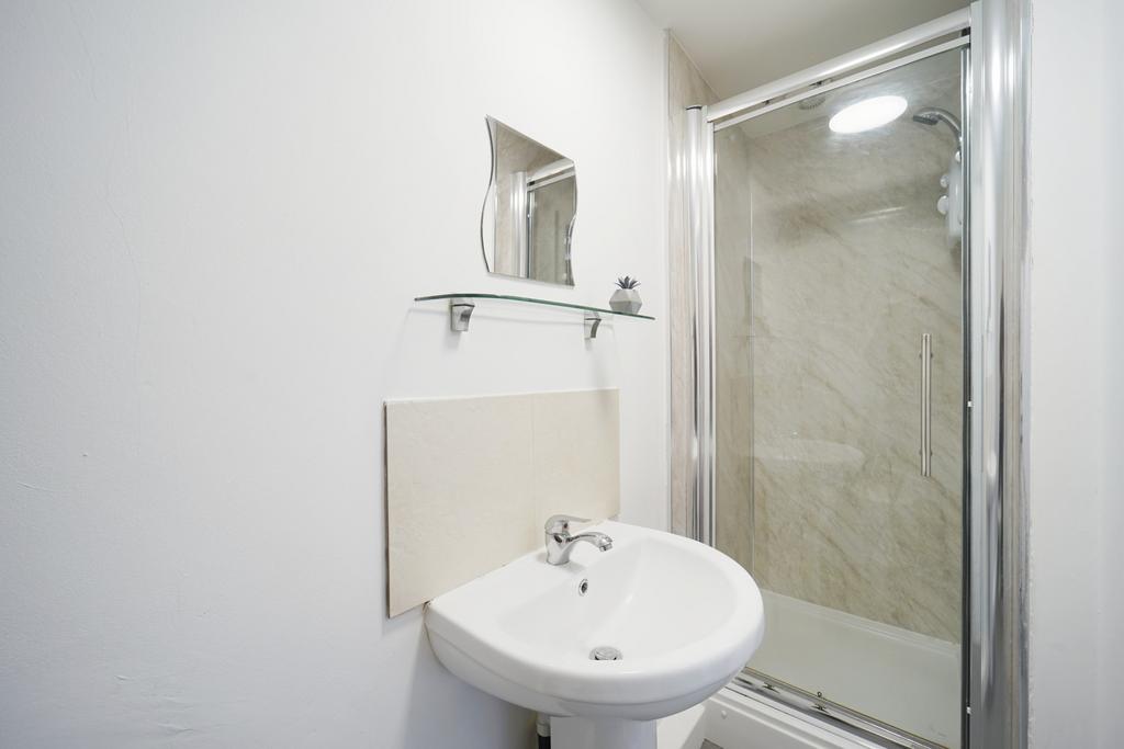 A clean and modern bathroom featuring a shower ...