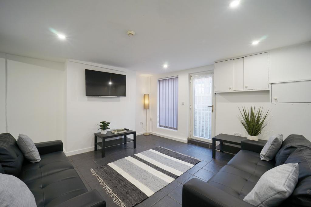 A modern, spacious living room featuring comfor...