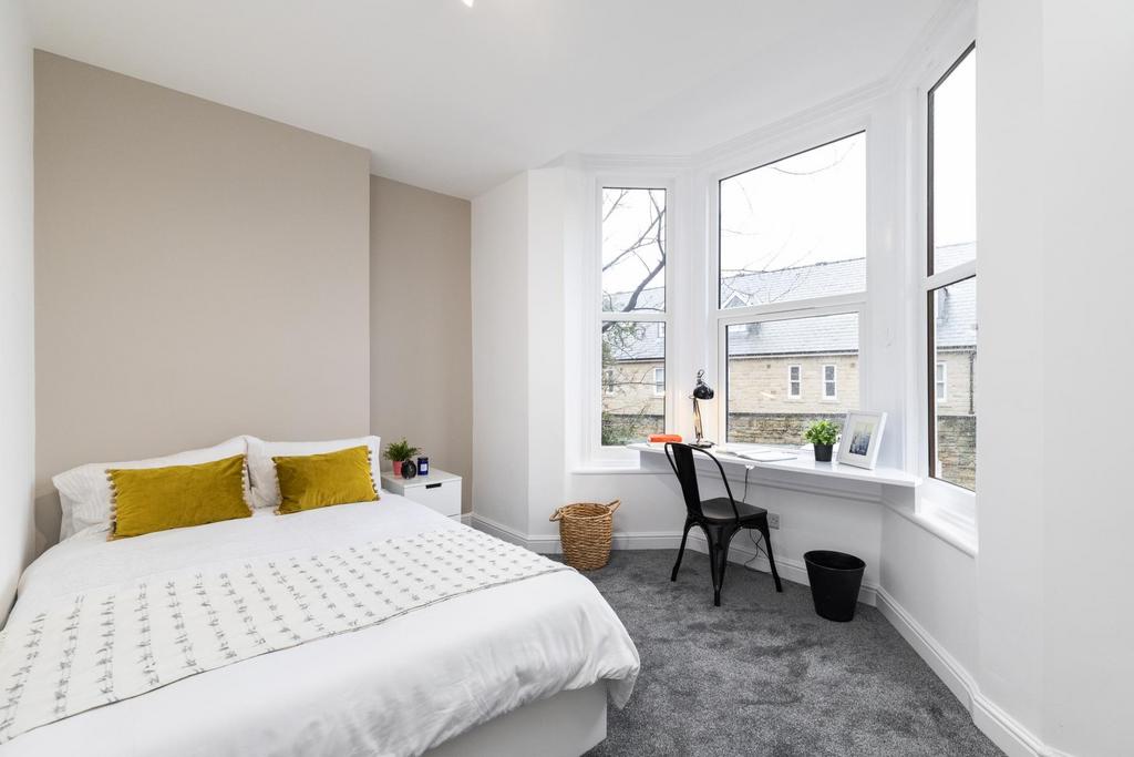 A bright and spacious master bedroom featuring ...
