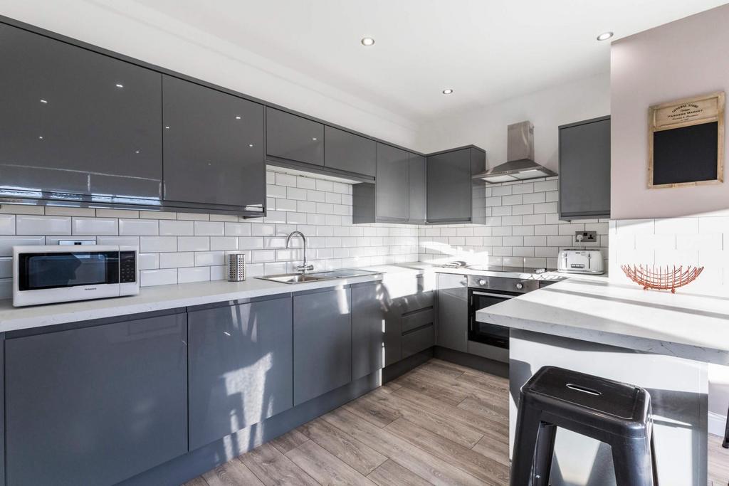 Modern and well-maintained kitchen featuring sl...