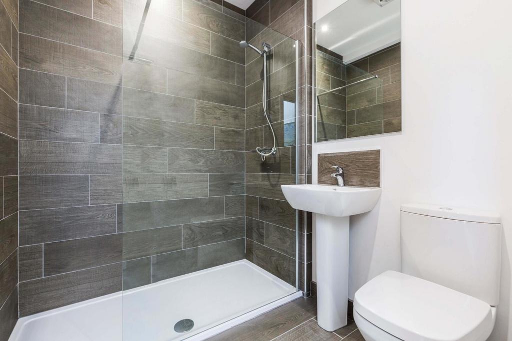 A modern, clean bathroom featuring a spacious s...