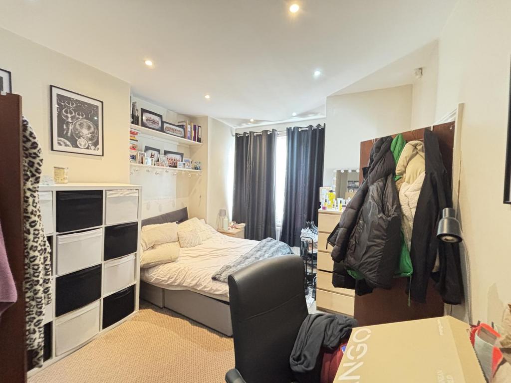 Cozy student bedroom featuring a double bed, fu...
