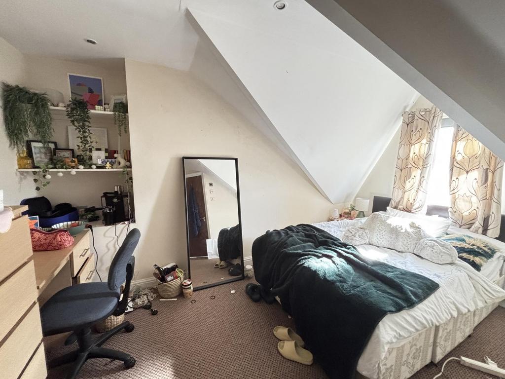 A spacious master bedroom with ample space for ...